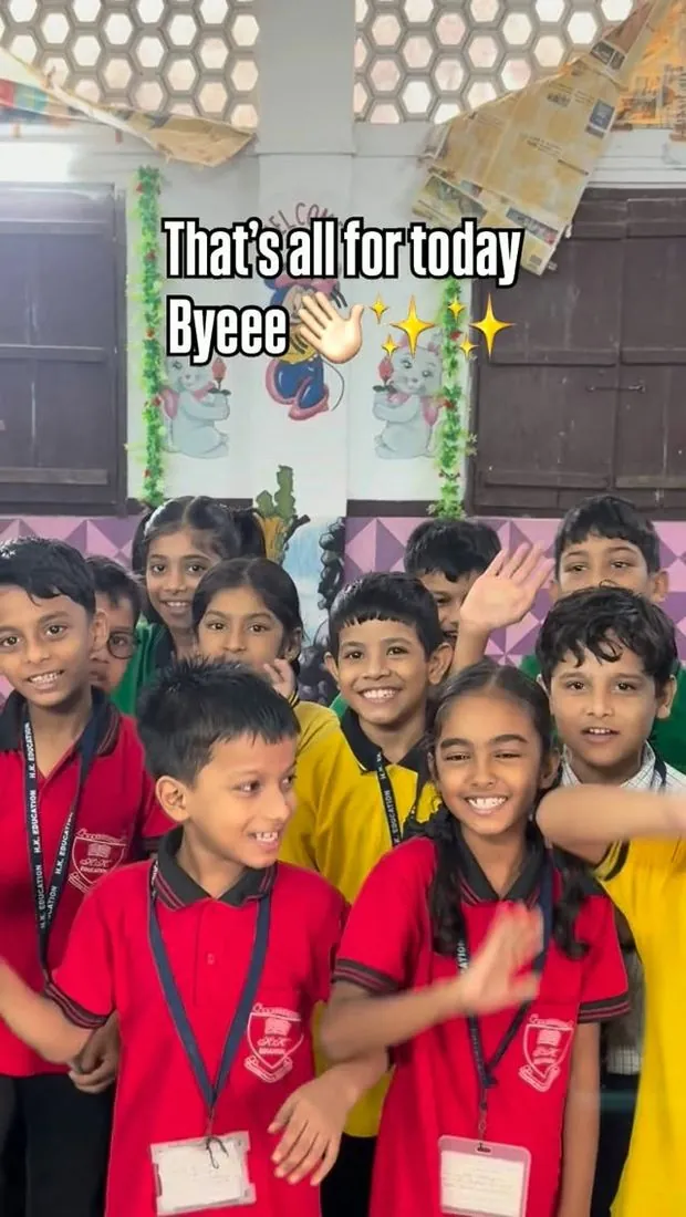 Young students waving at school